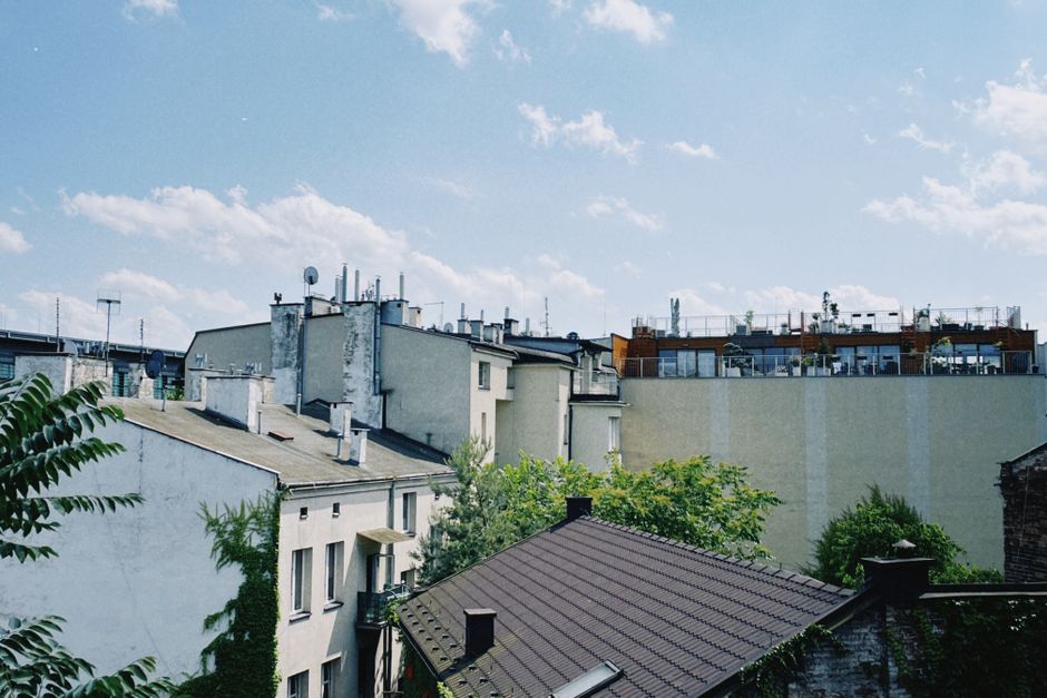 A picturesque view of Kraków's residential rooftops on a bright and sunny day. - Photo by Aibek Skakov on Pexels